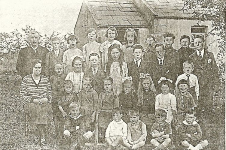 Mr S. Kerr (Principal) and Miss J. Robinson with a group of pupils outside Lisnalinchy School prior to its closing in 1928.
